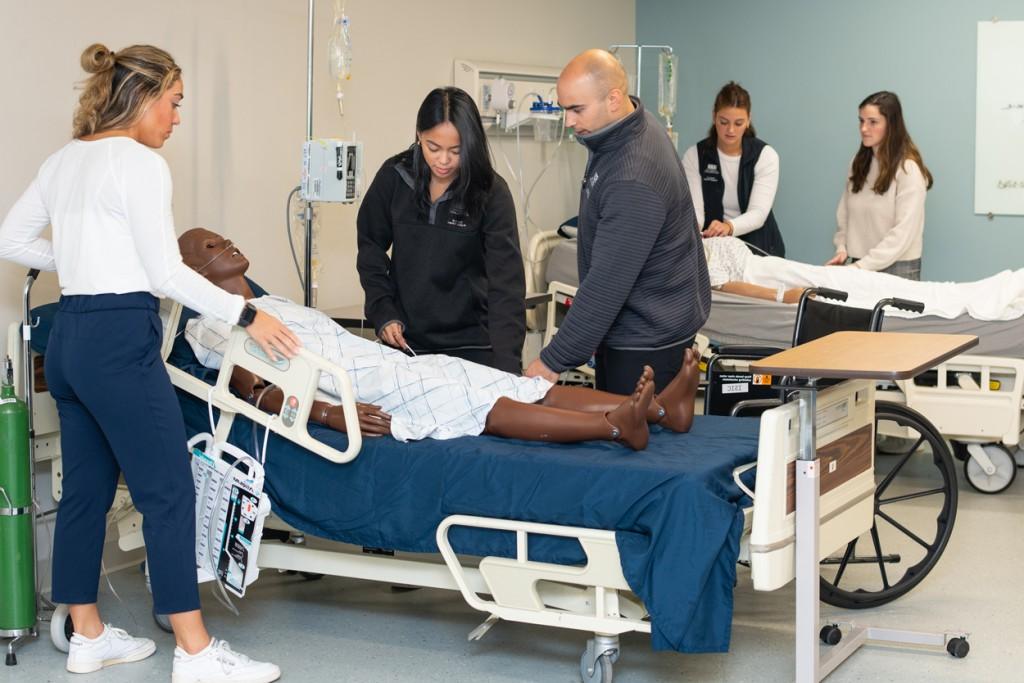 A group of physical therapy students in the simulation lab