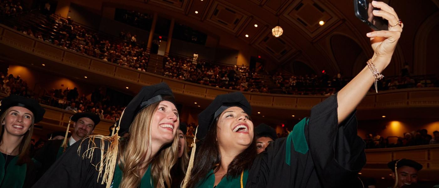 UNE COM graduates take a selfie at Merrill Auditorium in Portland